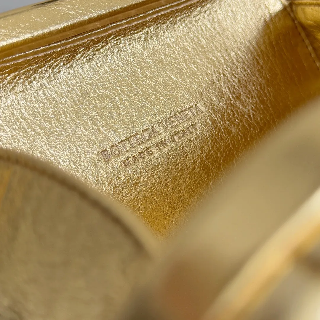 Batch 2100 BOTTEGA VENETA Women's Knot Evening Bag. An evening bag as beautiful as a jewelry box. Sharp-eyed friends must have discovered that the leather this time has a metallic luster. The whole bag looks very high-end. Even in a low-light environment, it is difficult to hide the excellent gloss of this bag. The three-dimensional flower made of brass will not oxidize. It is a heavy workmanship visible to the naked eye. Style number: 826183 (717622) Color: gold Size: 19*11.5*5cm
